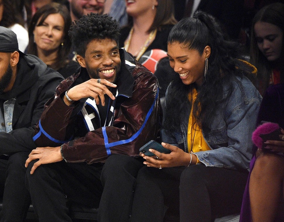 Chadwick Boseman (L) and Taylor Simone Ledward attend the 69th NBA All-Star Game at United Center on February 16, 2020 in Chicago, Illinois