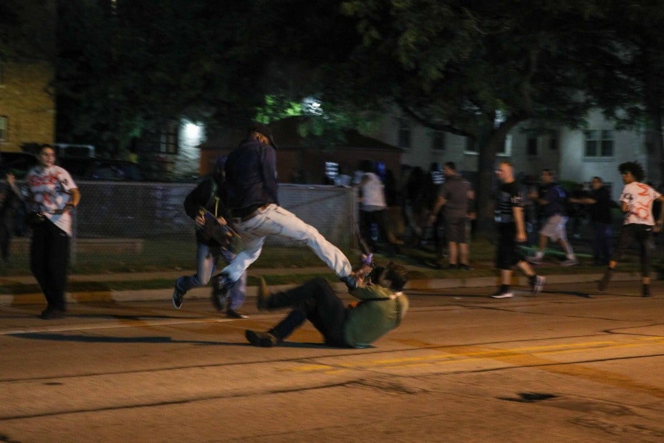 Clashes between protesters and armed civilians, who protect the streets of Kenosha against the arson, break out during the third day of protests over the shooting of a black man Jacob Blake by police officer in Wisconsin, United States on August 25, 2020.