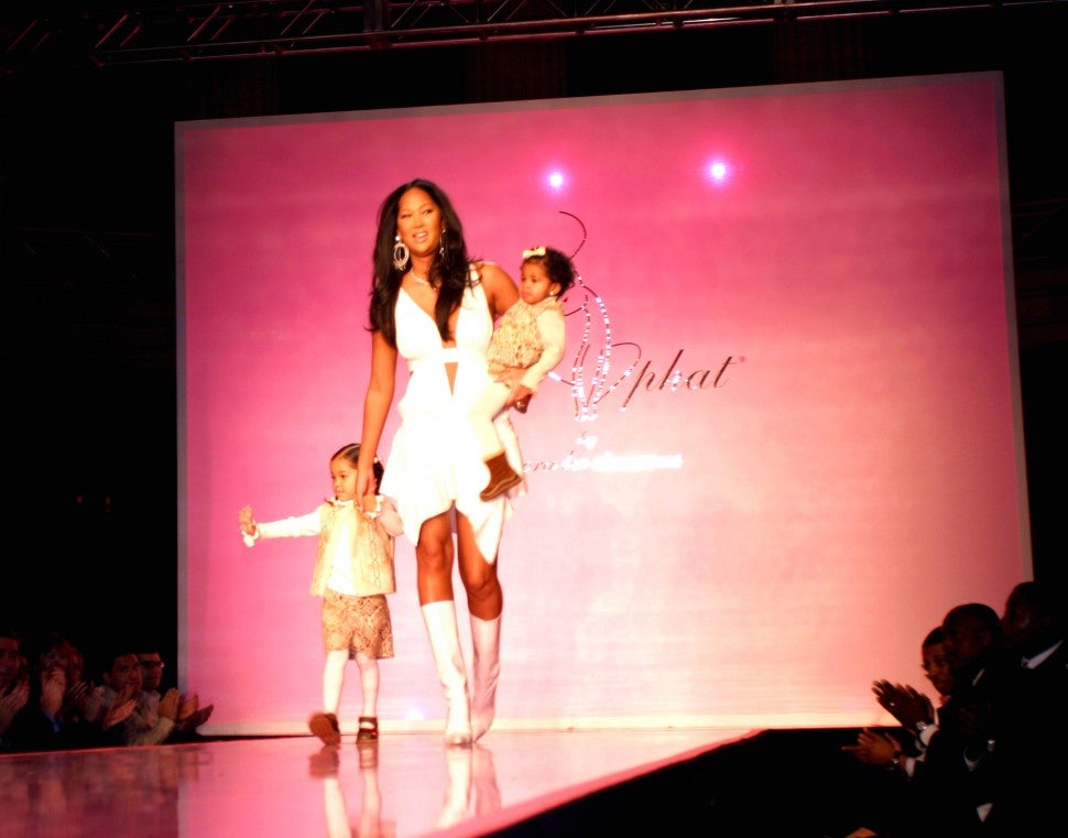 Kimora Lee Simmons is joined by daughters Ming and Aoki on the runway at her 2004 Baby Phat New York Fashion Week show.