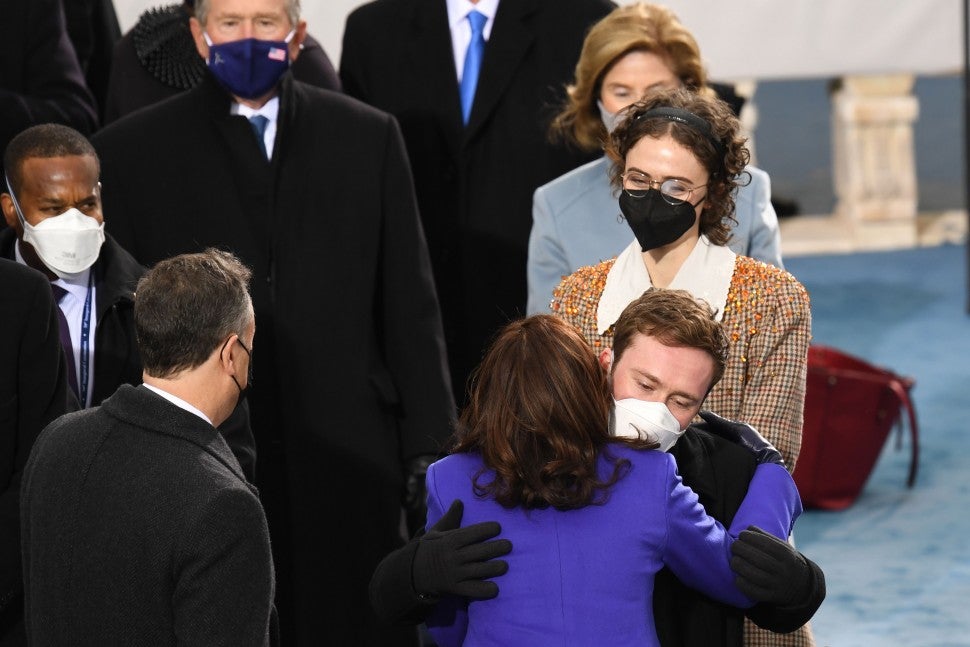 Kamala Harris (C, bottom) greets stepchildren Cole Emhoff and Ella Emhoff as she arrives for the inauguration of Joe Biden as the 46th US President on January 20, 2021, at the US Capitol in Washington, DC.
