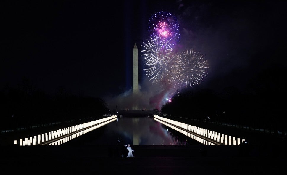 Singer Katy Perry (foreground) performs in front of a firework display during the "Celebrating America" event at the Lincoln Memorial after the inauguration of Joe Biden as the 46th President of the United States in Washington, DC, January 20, 2021.