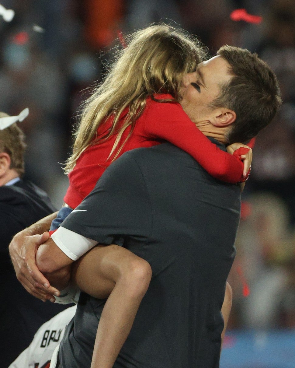 Tom Brady #12 of the Tampa Bay Buccaneers hugs his daughter Vivian after defeating the Kansas City Chiefs 31-9 in Super Bowl LV at Raymond James Stadium on February 07, 2021 in Tampa, Florida. 
