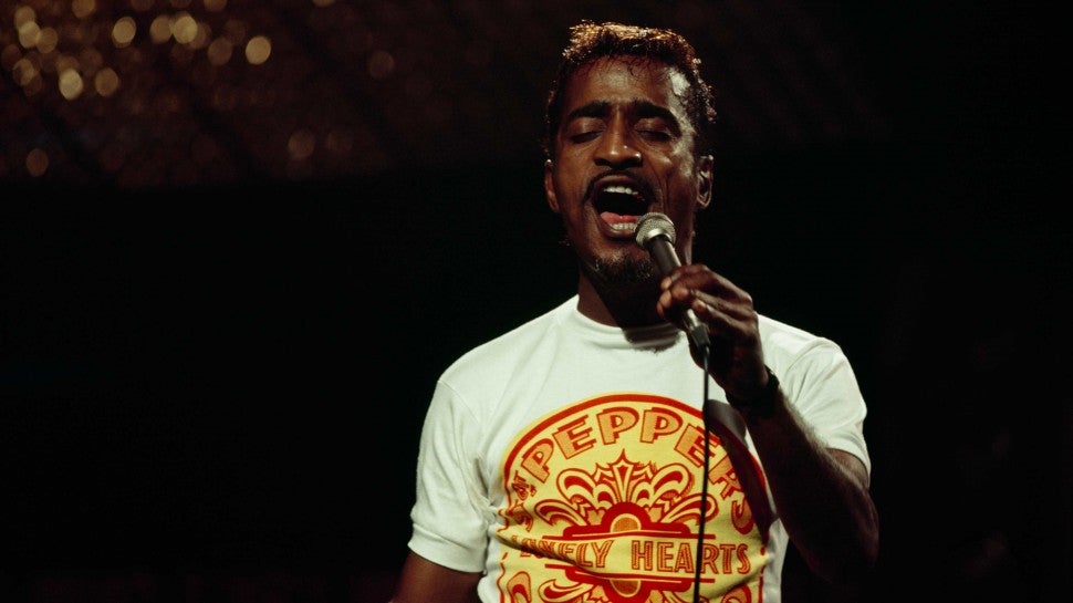 Sammy Davis Jr, wearing a Beatles t-shirt, performs on stage at The Talk of The Town in London, England in 1967.