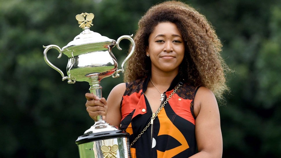 Japans Naomi Osaka poses with the 2021 Australian Open winner's trophy at the Government House in Melbourne on February 21, 2021, following her victory over Jennifer Brady of the US in the women's singles final of the tennis tournament. 