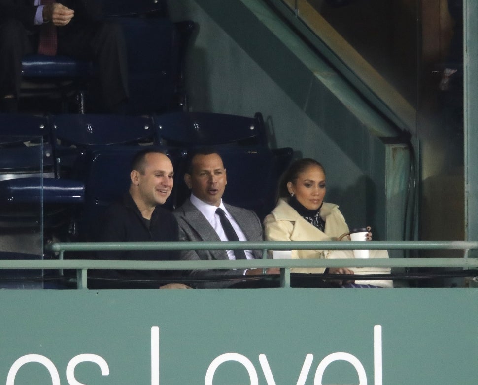 Jennifer Lopez, right, and Alex Rodriguez, center, watch the game. The Boston Red Sox host the Los Angeles Dodgers in Game Two of the World Series at Fenway Park in Boston on Oct. 24, 2018. 