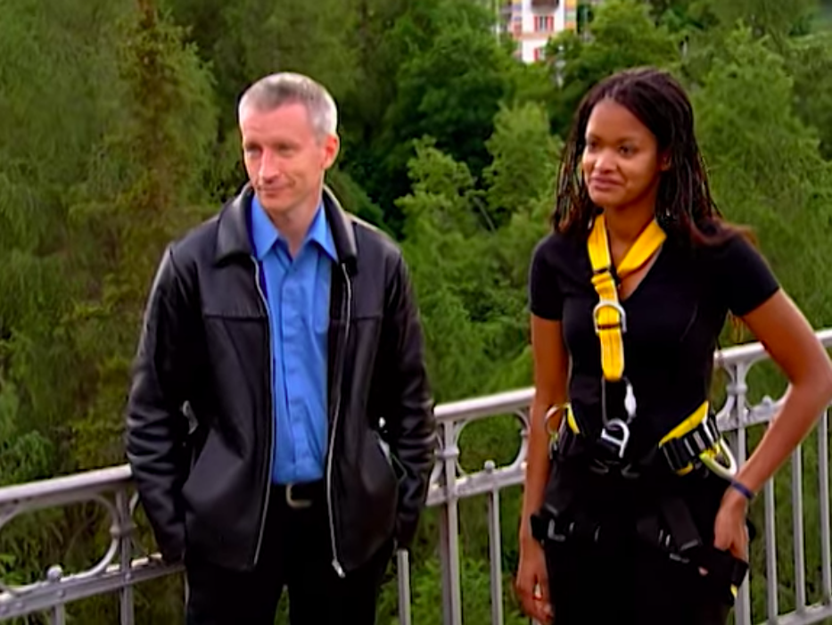 Anderson Cooper stands with a player during 'The Mole.'