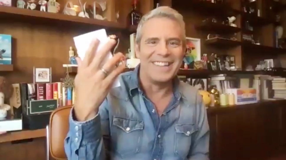 Andy Cohen holds up a potential cast list for season 14 of Bravo's The Real Housewives of Atlanta.