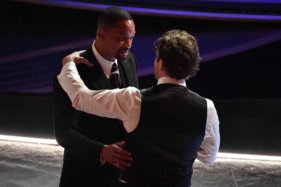 Will Smith (L) speaks with US actor and director Bradley Cooper during the 94th Oscars at the Dolby Theatre in Hollywood, California on March 27, 2022. 