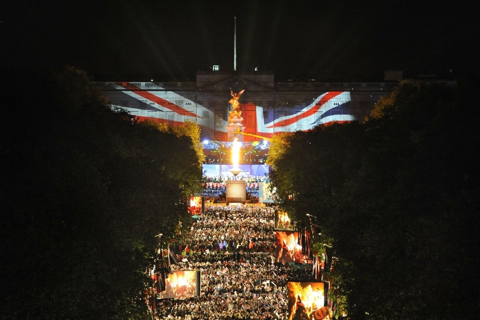 A beacon (C) is lit by Queen Elizabeth II amid a fireworks display outside Buckingham Palace in London, on June 4, 2012, to mark the end of the Diamond Jubilee Concert.
