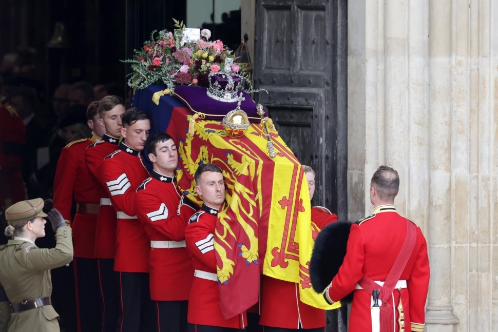 The coffin of Queen Elizabeth II with the Imperial State Crown resting on top is carried by the Bearer Party as it departs Westminster Abbey during the State Funeral of Queen Elizabeth II on September 19, 2022 in London, England