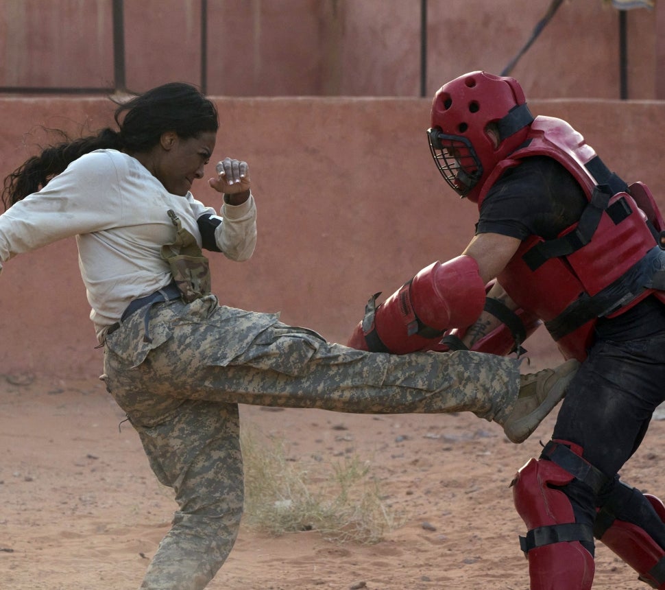 Kenya Moore kicks a challengers on Special Forces: World's Toughest Test