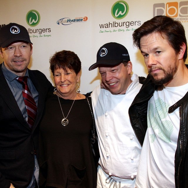 Donnie Wahlberg, their mother Alma Elaine Wahlberg, chef Paul Wahlberg and Mark Wahlberg attend the grand opening of Wahlburgers on October 24, 2011 at the Hingham Shipyard in Boston, Massachusetts.