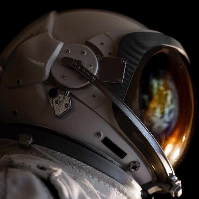 Close-Up Of Astronaut Against Black Background - stock photo