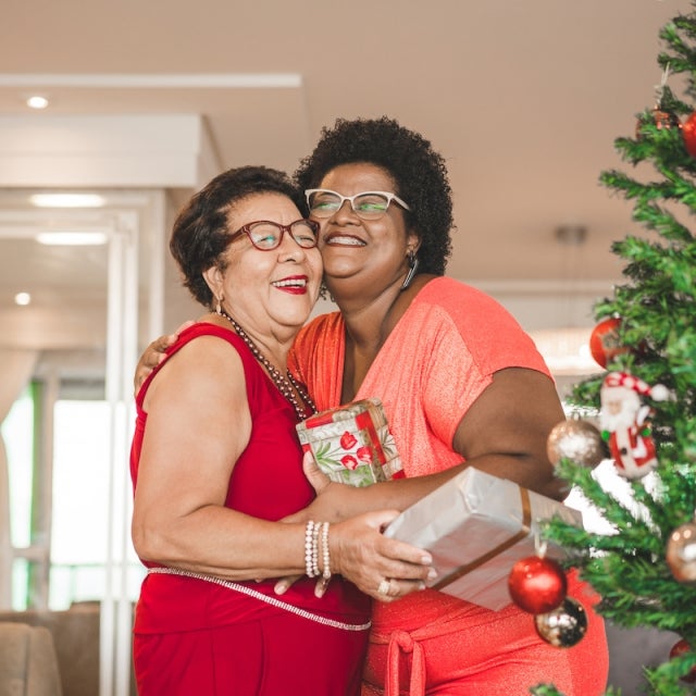 Mom and daughter hug while exchanging gifts