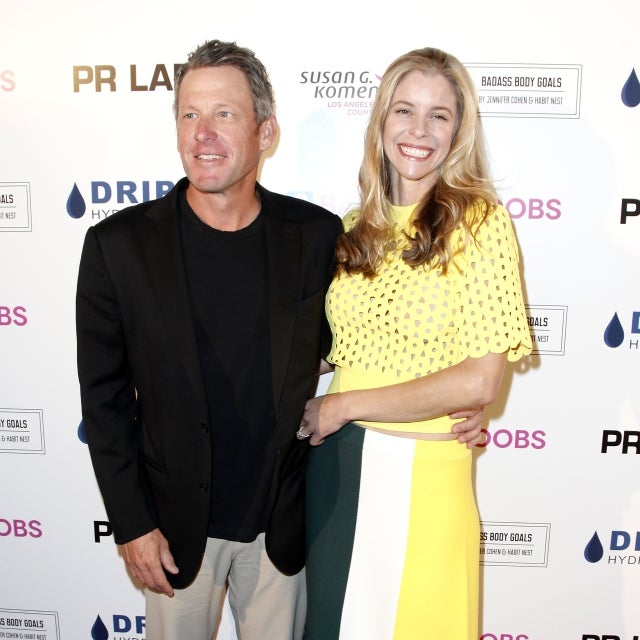 Lance Armstrong and Anna Hansen. Armstrong wears a dark suit and Hansen wears a yellow dress.
