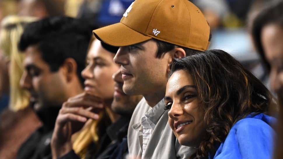 Ashton Kutcher and Mila Kunis attend the game between the Los Angeles Dodgers and the Oakland Athletics at Dodger Stadium on April 11, 2018 in Los Angeles, California.