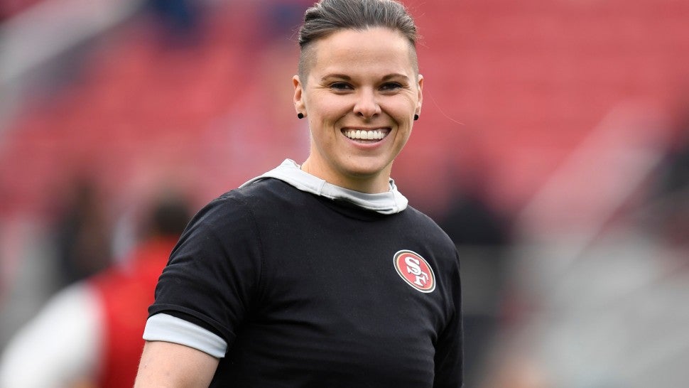 San Francisco 49ers offensive assistant Katie Sowers stands on the field before their NFC Championship game against the Green Bay Packers at Levi's Stadium in Santa Clara, Calif., on Sunday, Jan. 19, 2020