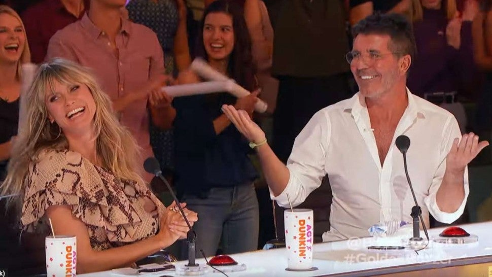 Agt Champions Simon Cowell Steals Howie Mandel S Golden Buzzer