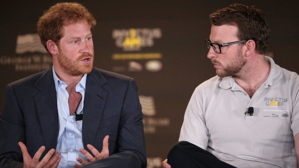 Lance Corporal John-James Chalmers, former Royal Marine Commando looks on (R) while Britain's Prince Harry, Patron of the Invictus Games Foundation, speaks during the 2016 Invictus Games Symposium on Invisible Wounds in Orlando, Florida, May 8, 2016.