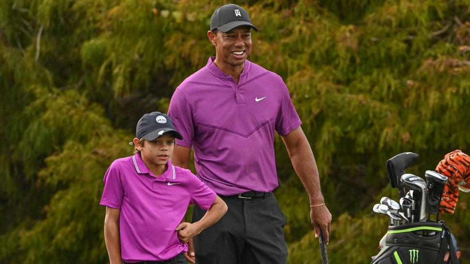 Tiger Woods smiles while standing with his son Charlie Woods on the 16th green during the first round of the PGA TOUR Champions PNC Championship at Ritz-Carlton Golf Club on December 19, 2020 in Orlando, Florida.