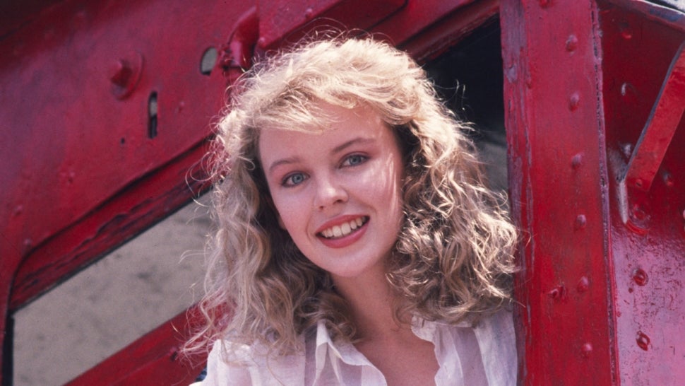 Kylie Minogue poses with a train to promote 'The Loco-Motion' in 1988. 