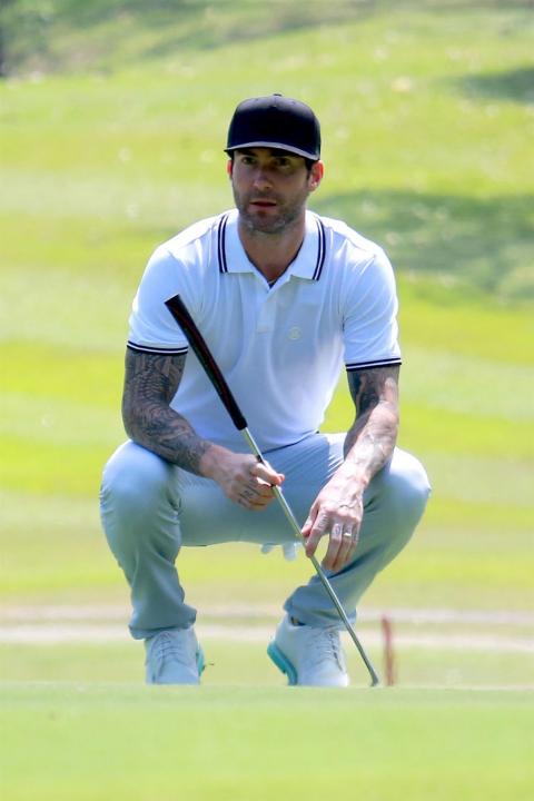 Adam Levine plays golf in Rio