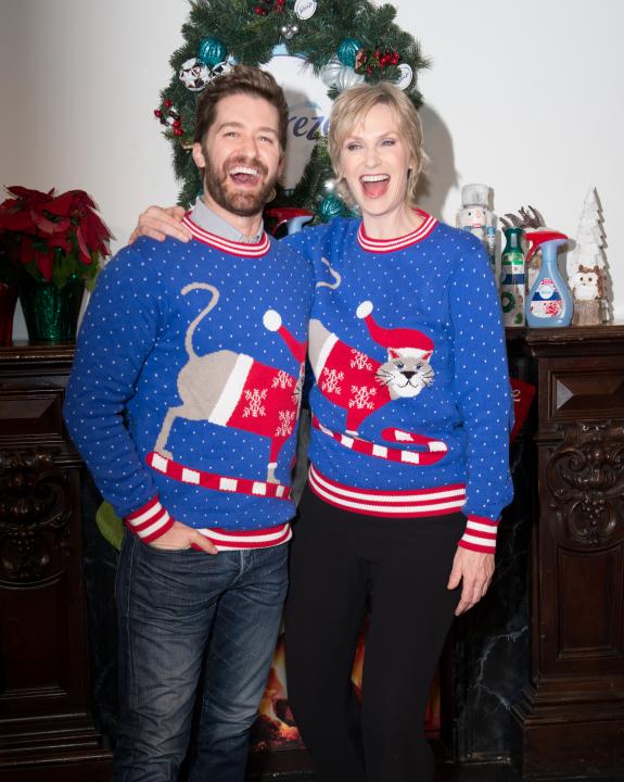 Matthew Morrison and Jane Lynch in ugly Xmas sweaters