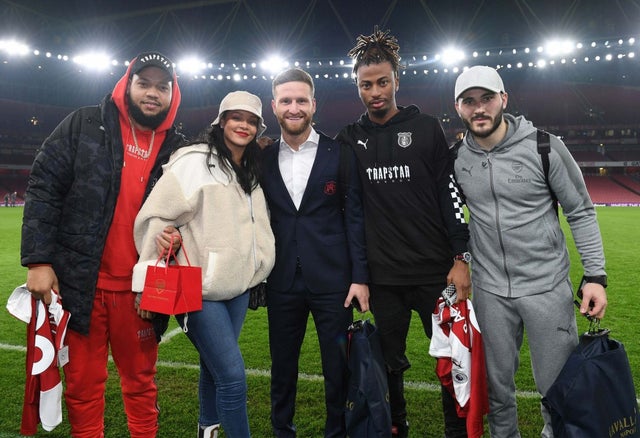 Rihanna with Arsenal footbal club members in London