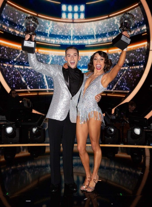 Adam Rippon and Jenna Johnson hold their Mirrorball Trophies After Winning 'DWTS'