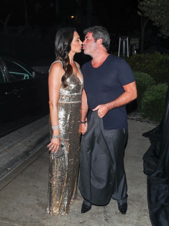 Simon Cowell kisses girlfriend Lauren Silverman at AGO