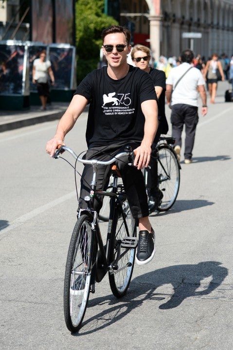 Nicholas Hoult rides bike at venice film festival