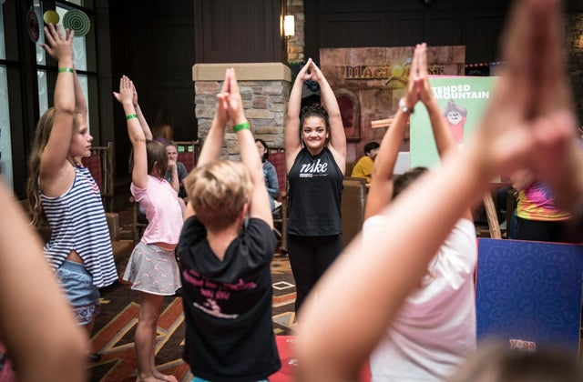 Laurie Hernandez teaching yoga tails class