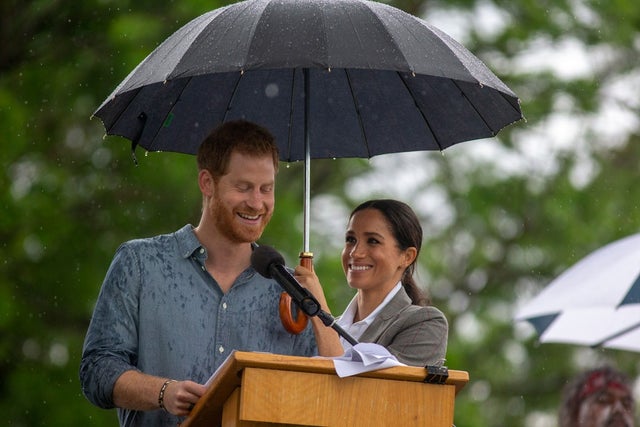 Prince Harry and Meghan Markle in rain in australia