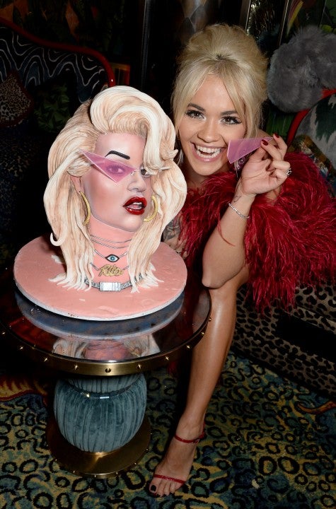 Rita Ora eats cake at her album launch party