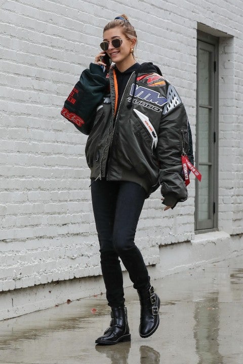 Hailey Baldwin in Vetements jacket going to photo shoot in the rain