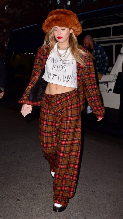 Miley Cyrus in protect kids not guns tee and plaid suit in NYC