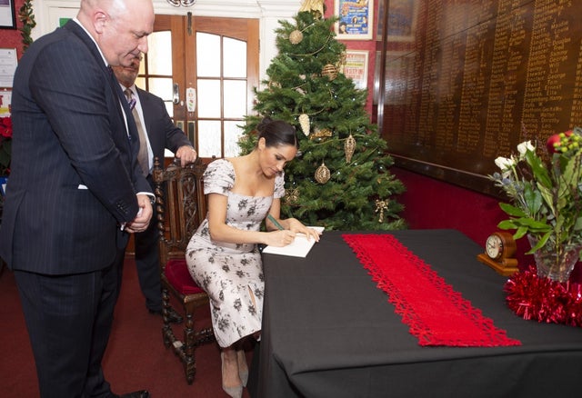 Meghan Markle signs card at Brinsworth House