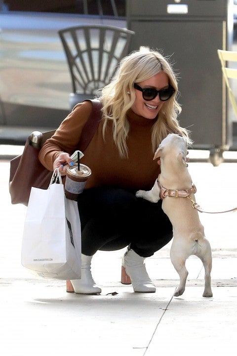 Hilary Duff pets a dog at joan's on third