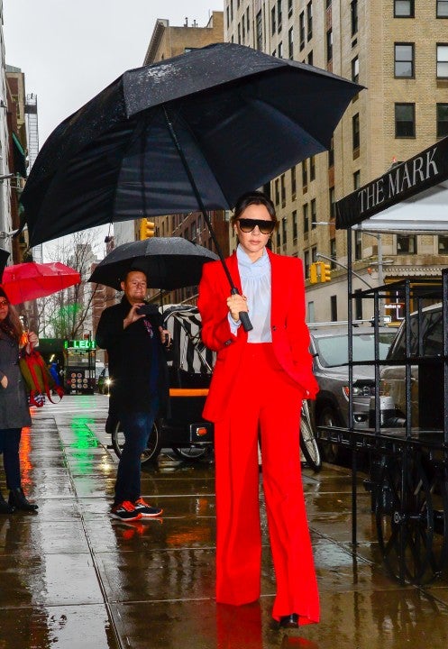 Victoria beckham wears red suit in the rain