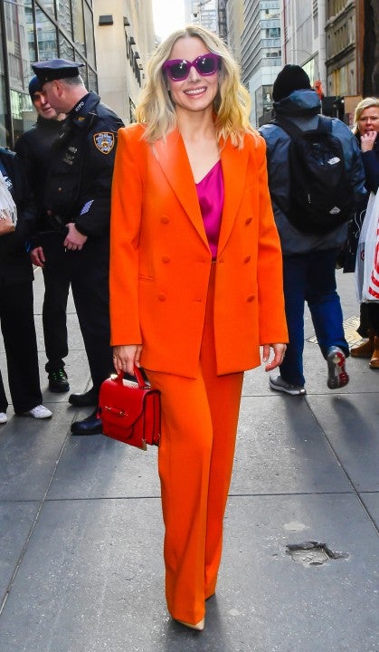 Kristen Bell in nyc in neon orange suit