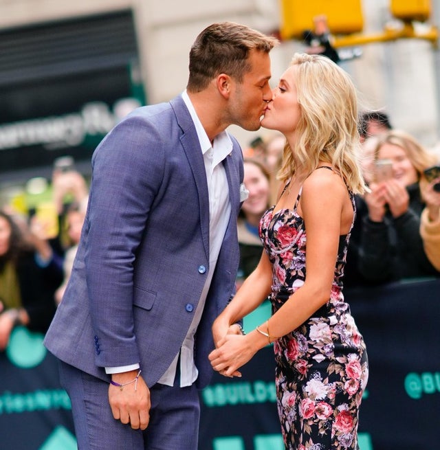 Colton Underwood and Cassie Randolph kiss outside of AOL Build