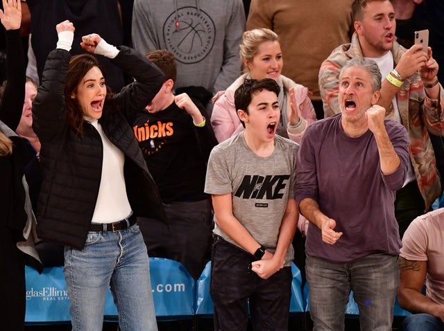 Emmy Rossum, Nathan Stewart and Jon Stewart attend Los Angeles Lakers v New York Knicks game