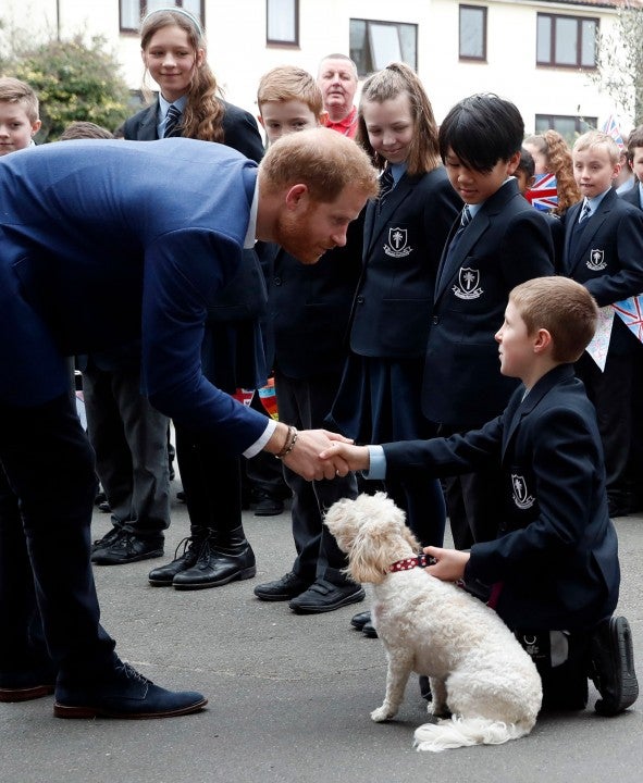 Prince Harry visits catholic school kids and dog