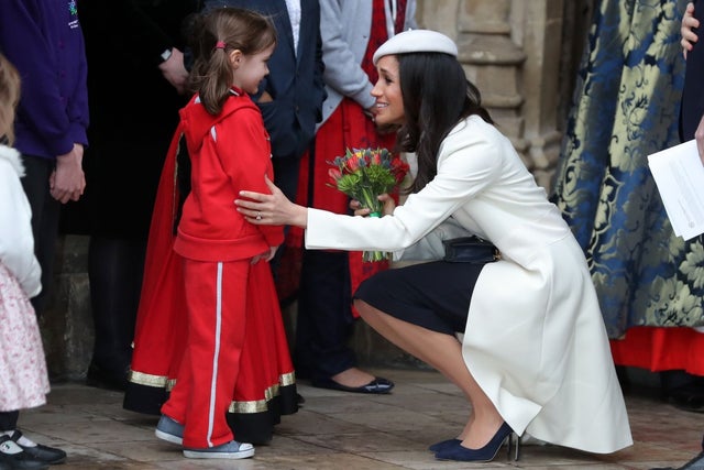 Meghan Markle receives flowers from a young girl after commonwealth services