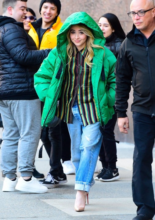 Sabrina Carpenter in green coat outside z100