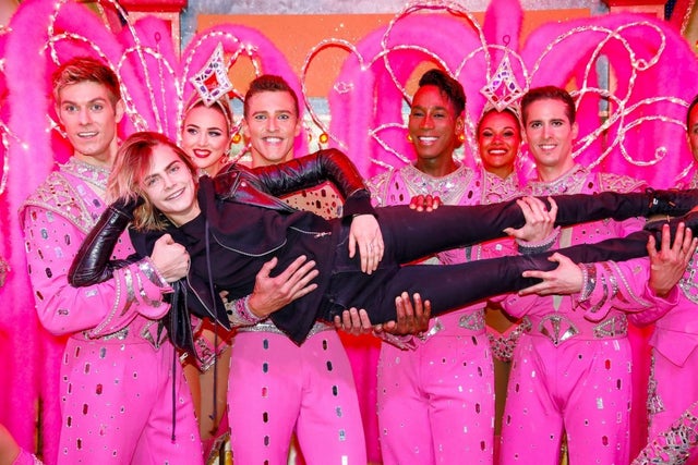 Cara Delevingne poses with the Moulin Rouge dancers in France