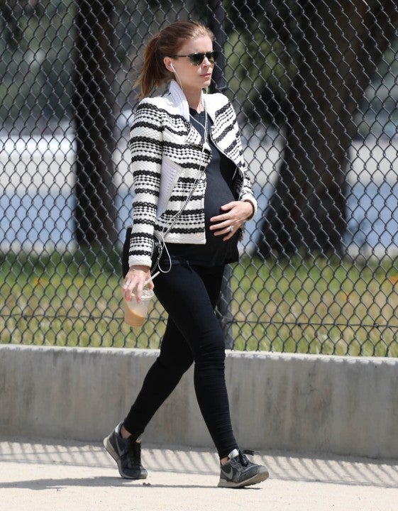 Kate Mara cradles baby bump in LA