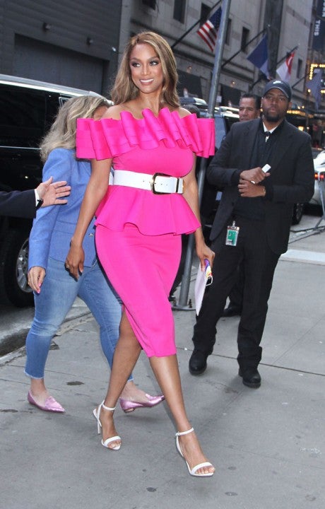 Tyra Banks in neon pink dress in nyc