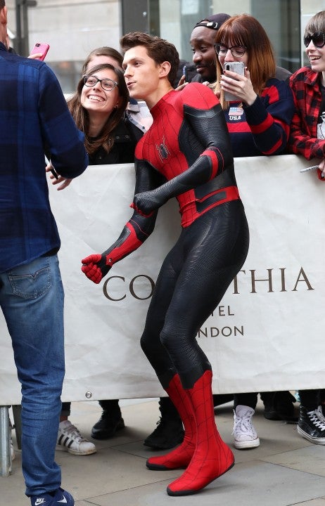 Tom Holland in spider-man costume in london 