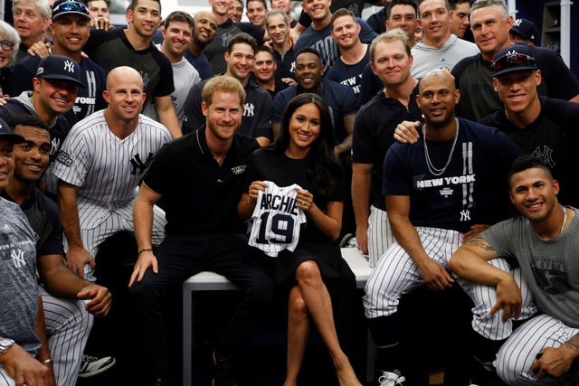 Prince harry and meghan markle with yankees and archie onesie in London